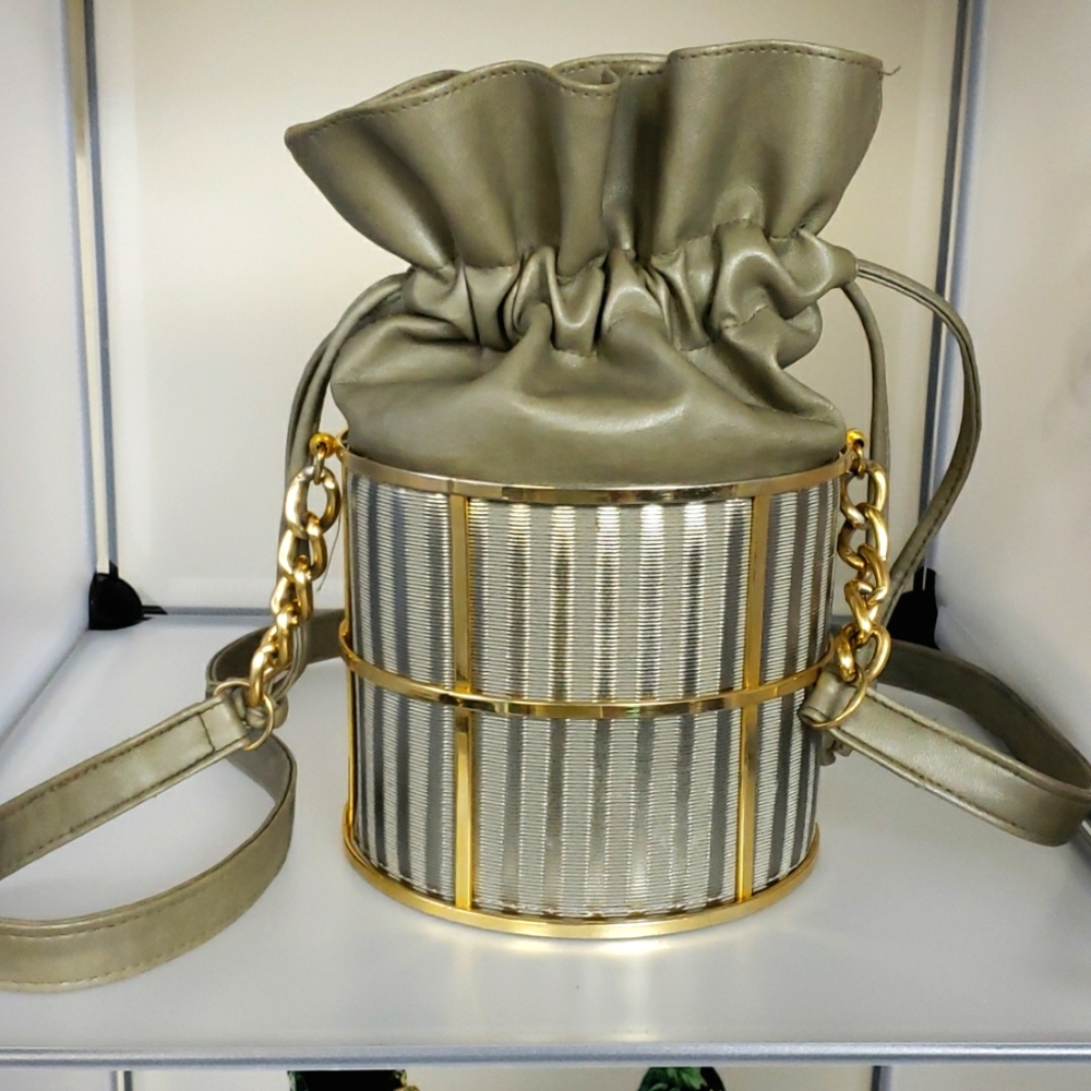 Unique bucket bag in everyday taupe/grayish faux leather with gold cage detail